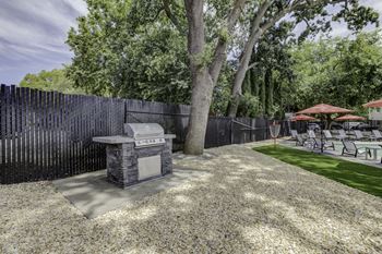 a backyard with a barbecue grill and tables and chairs at Gateway, Chico, CA